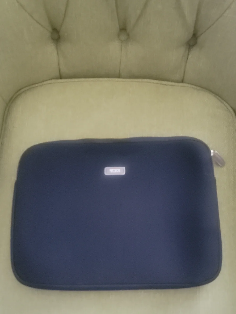 Tumi Black Sleeve with Beige Logo Patch